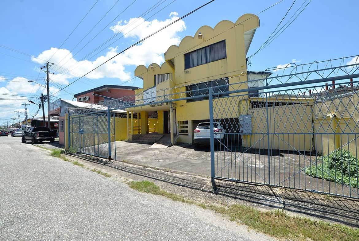Cornerstone- Commercial building on Sellier Street, Curepe with parking and security gate.