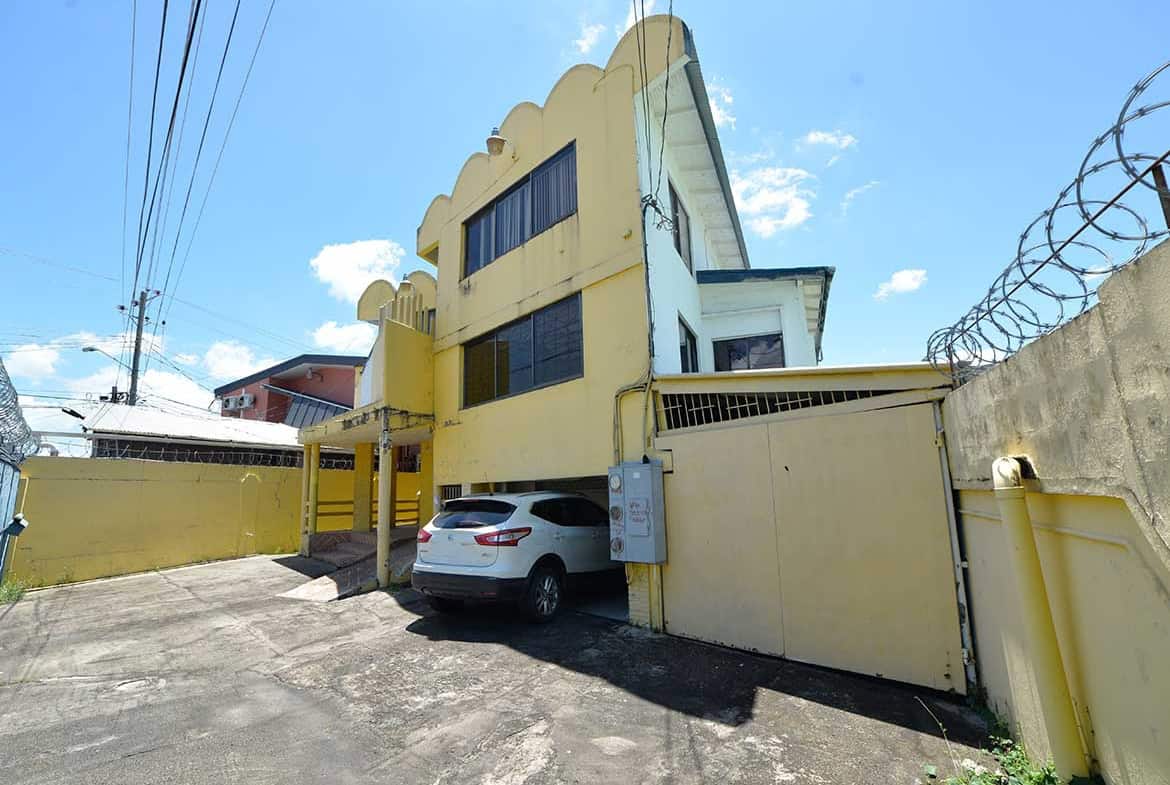 Cornerstone- Multi-story commercial building on Sellier Street, Curepe with parking area.