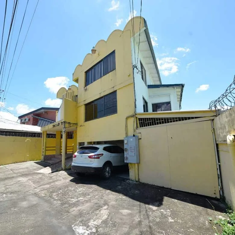 Cornerstone- Multi-story commercial building on Sellier Street, Curepe with parking area.
