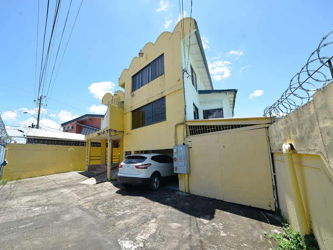 Cornerstone- Multi-story commercial building on Sellier Street, Curepe with parking area.