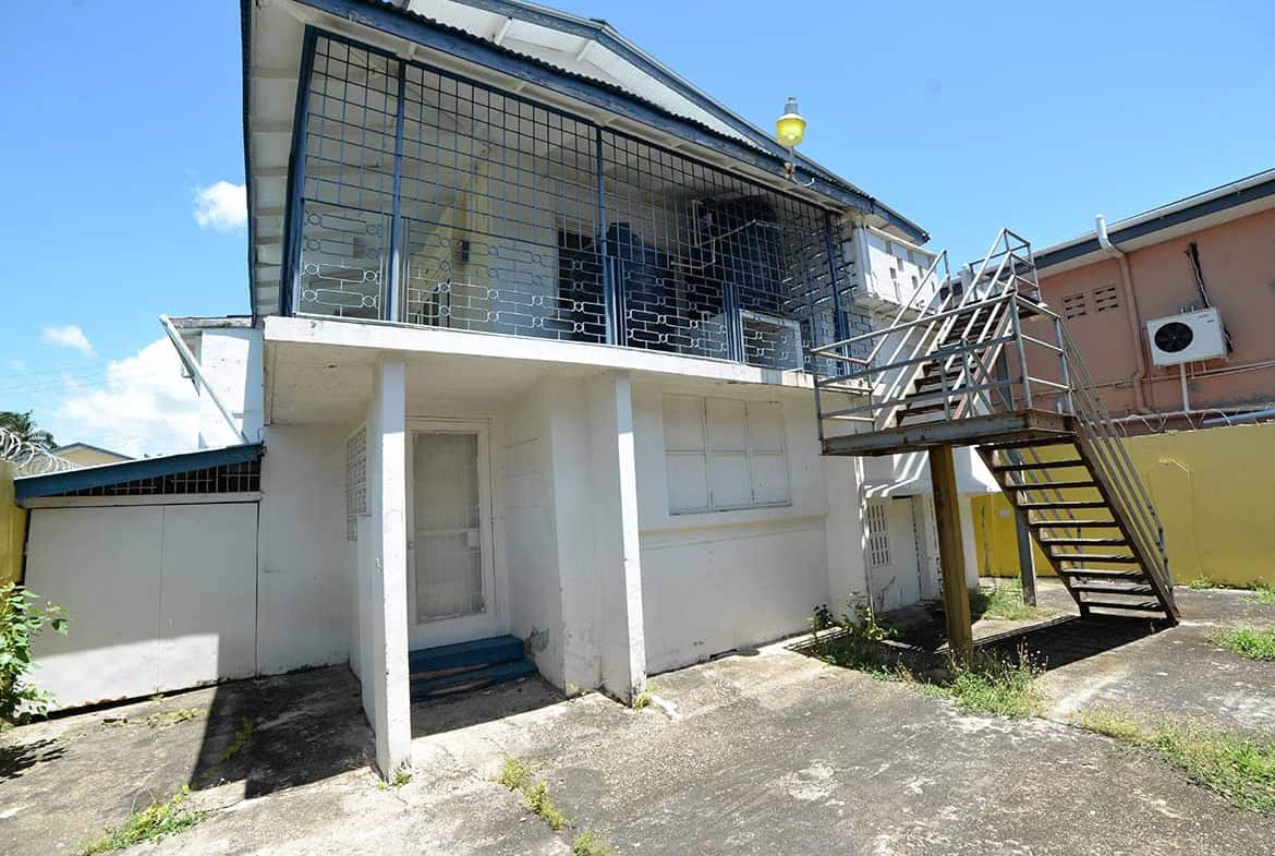 Cornerstone- Modern house with glass balcony and external staircase in Curepe.