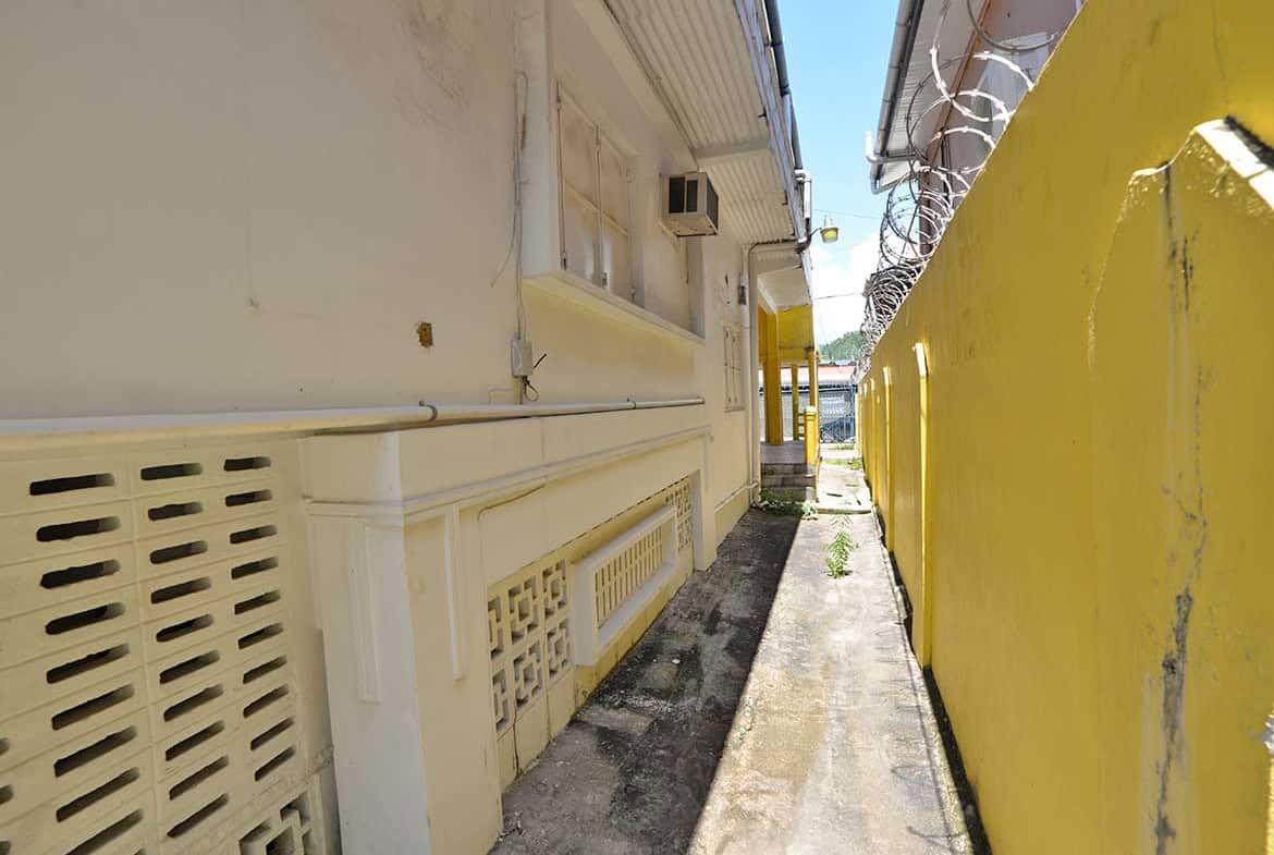 Cornerstone- Narrow alleyway between buildings on Sellier Street, Curepe.