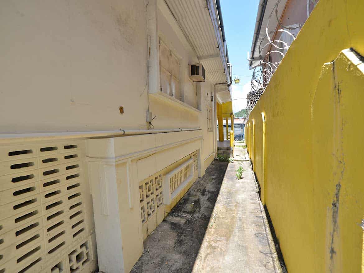 Sellier Street, Curepe – Cornerstone™ Cornerstone- Narrow alleyway between buildings on Sellier Street, Curepe.