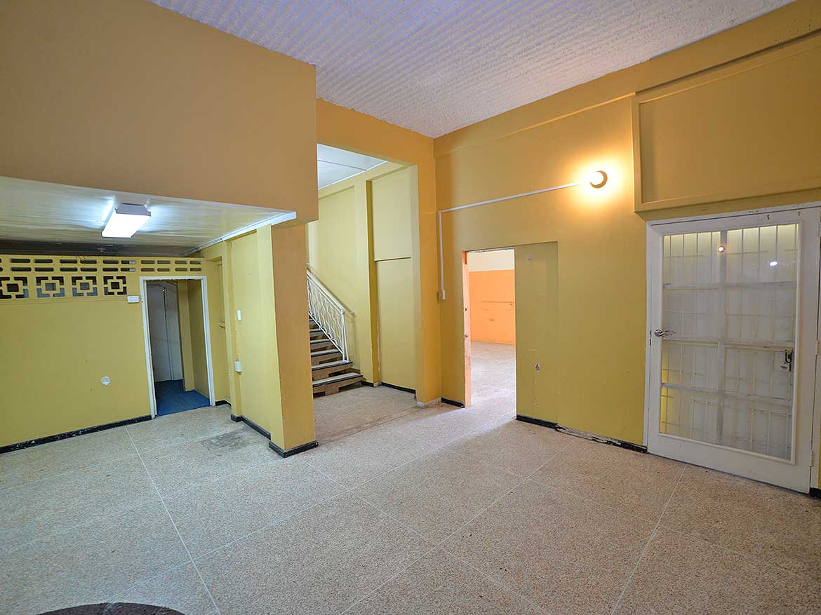 Interior of Cornerstone™ Property in Curepe Cornerstone- Spacious interior of Cornerstone™ property in Curepe with yellow walls and staircase.
