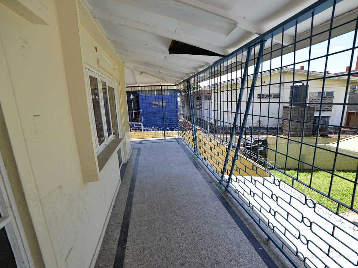 Cornerstone™ Residential Balcony View Cornerstone- Balcony with safety grill overlooking neighboring buildings and yard.