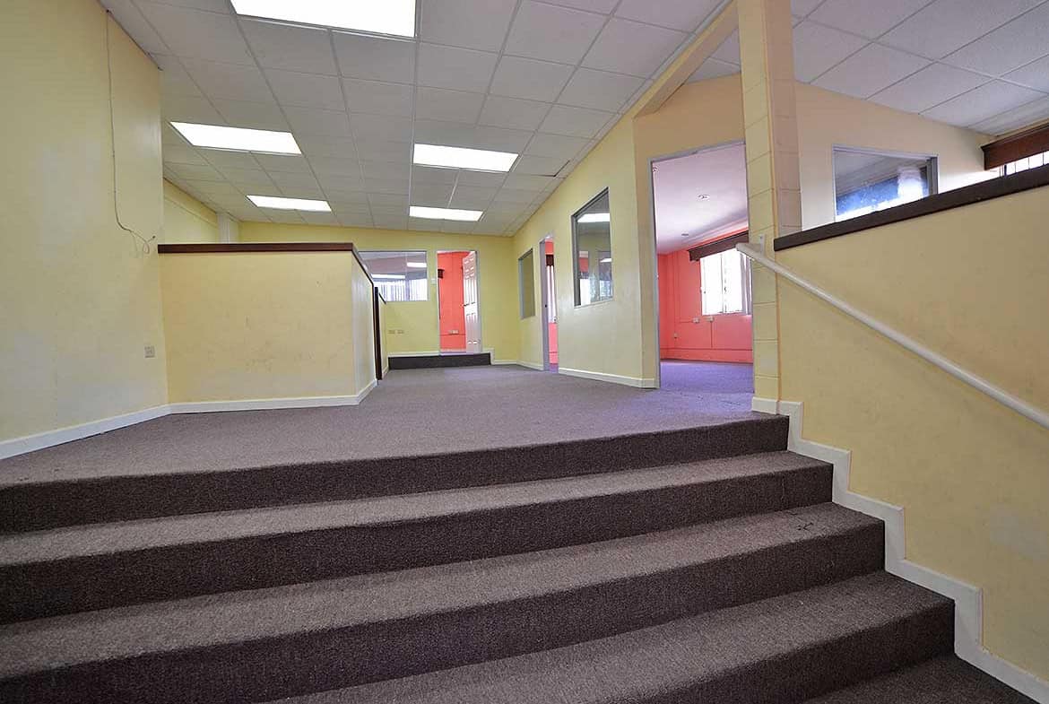 Cornerstone- Interior view of Cornerstone™ office in Curepe with stairs and hallway.