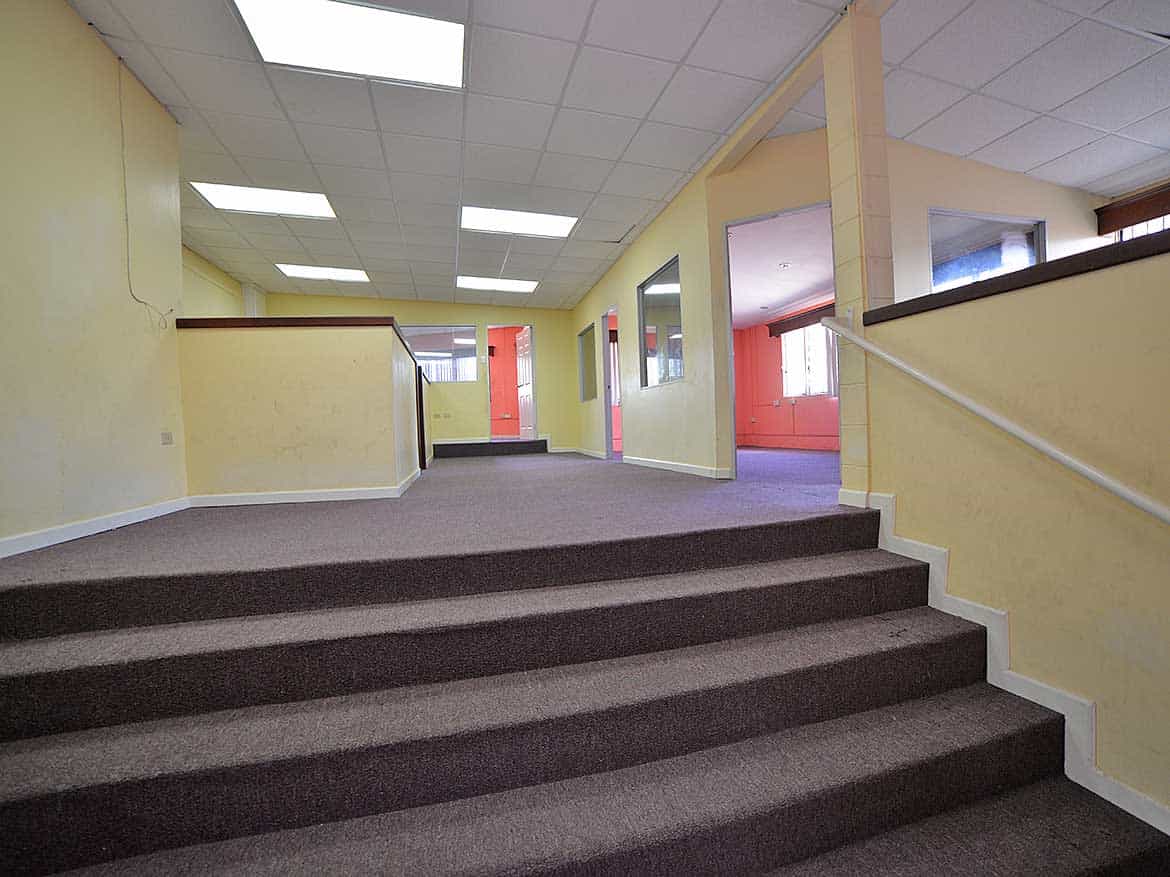Cornerstone™ Office Interior in Curepe Cornerstone- Interior view of Cornerstone™ office in Curepe with stairs and hallway.