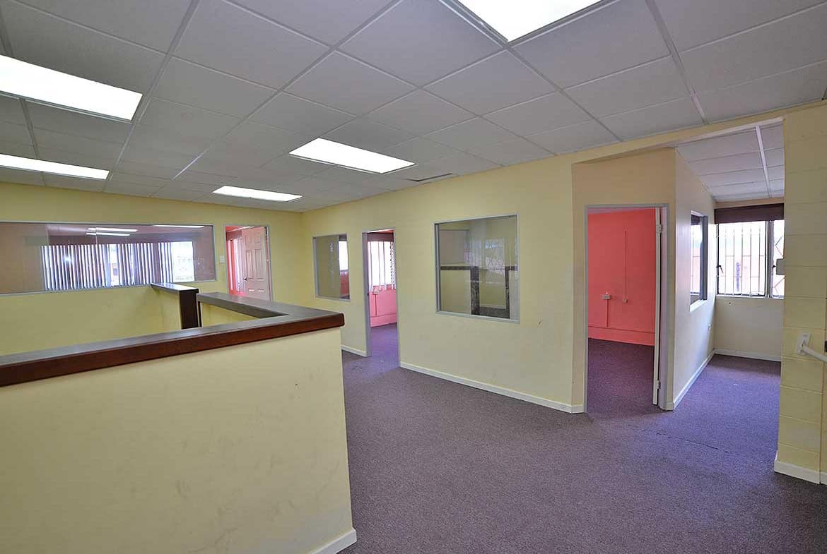 Cornerstone- Interior view of office space on Sellier Street Curepe with multiple rooms and windows.