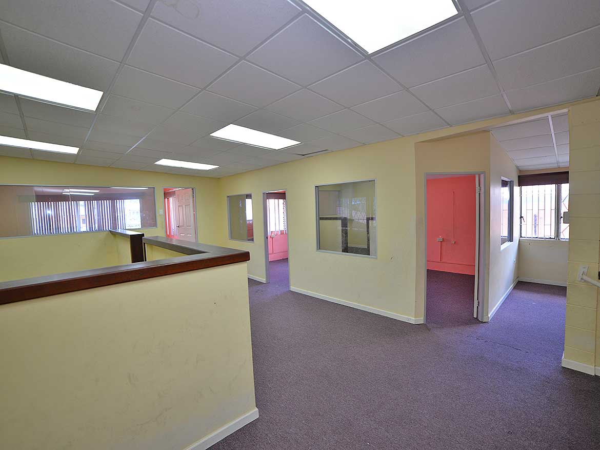 Office Space at Sellier Street Curepe Cornerstone- Interior view of office space on Sellier Street Curepe with multiple rooms and windows.