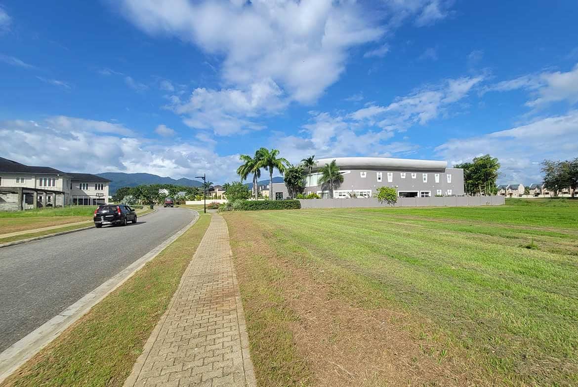 Cornerstone- Scenic view of Villas at Millennium Lakes with green lawns and blue sky.