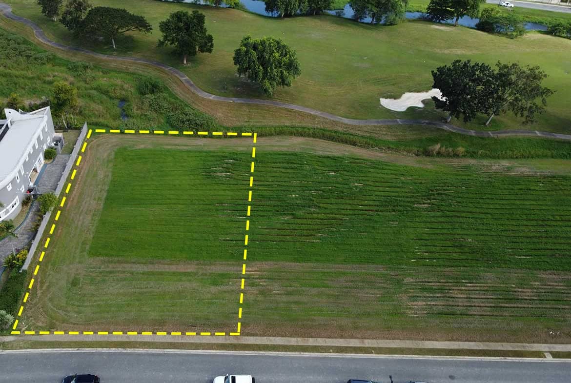 Cornerstone- Empty plot of land for sale at Villas at Millennium Lakes, surrounded by greenery.