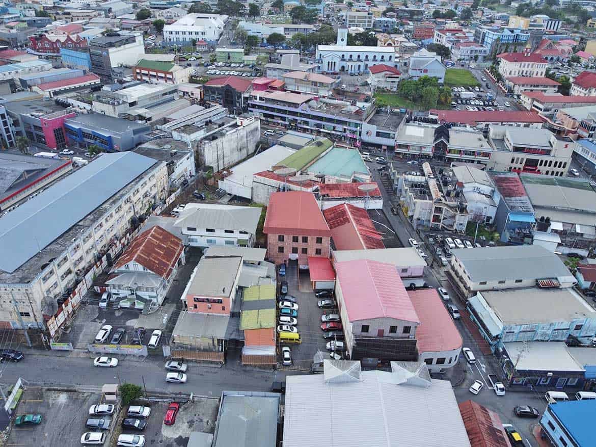St James Street Commercial Area Cornerstone- Aerial view of St James Street with shops and parking lots in Port of Spain.