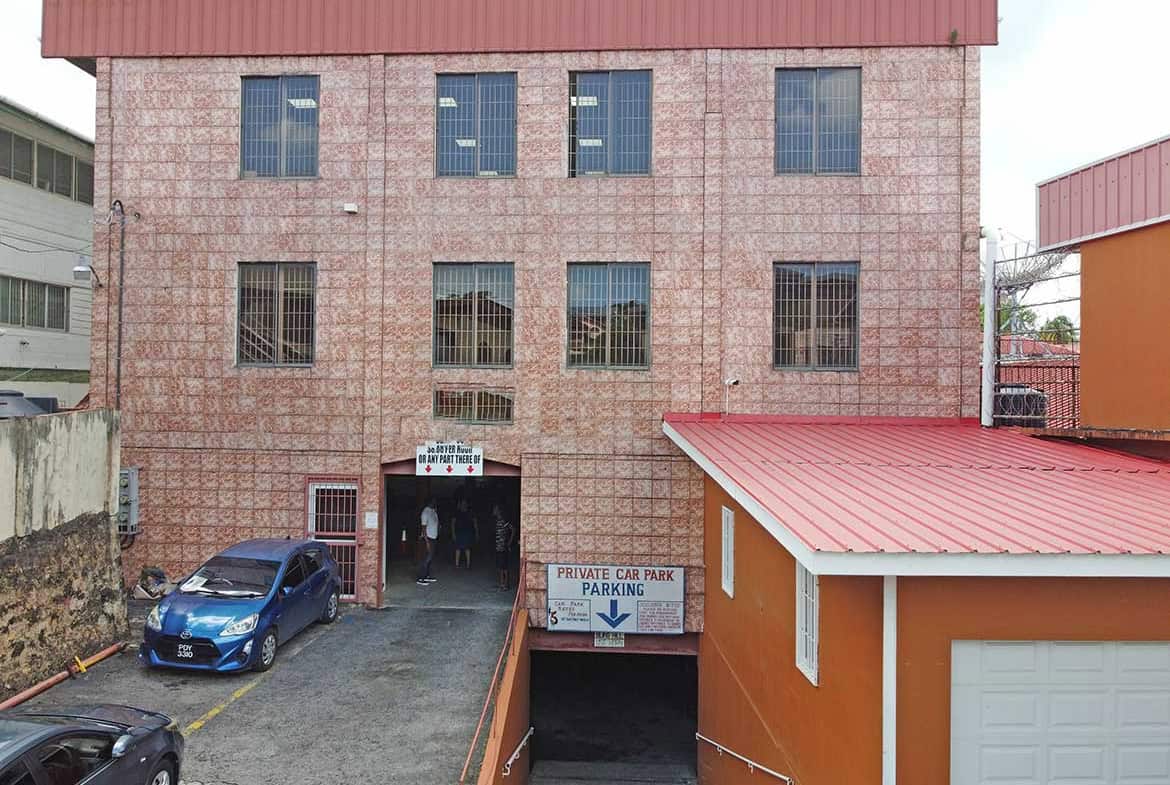 Cornerstone- Multi-story brick building with parking garage entrance on St James Street.