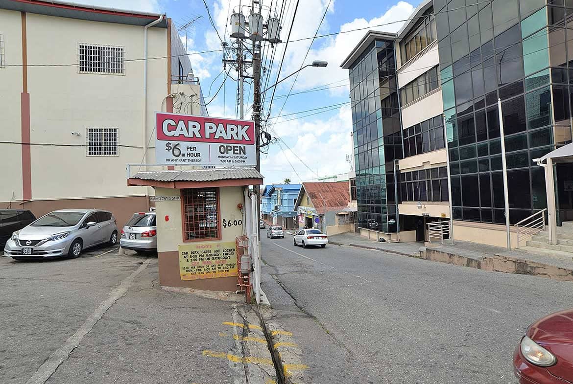 Cornerstone- Parking lot with sign for Cornerstone™ on St James Street, Trinidad.
