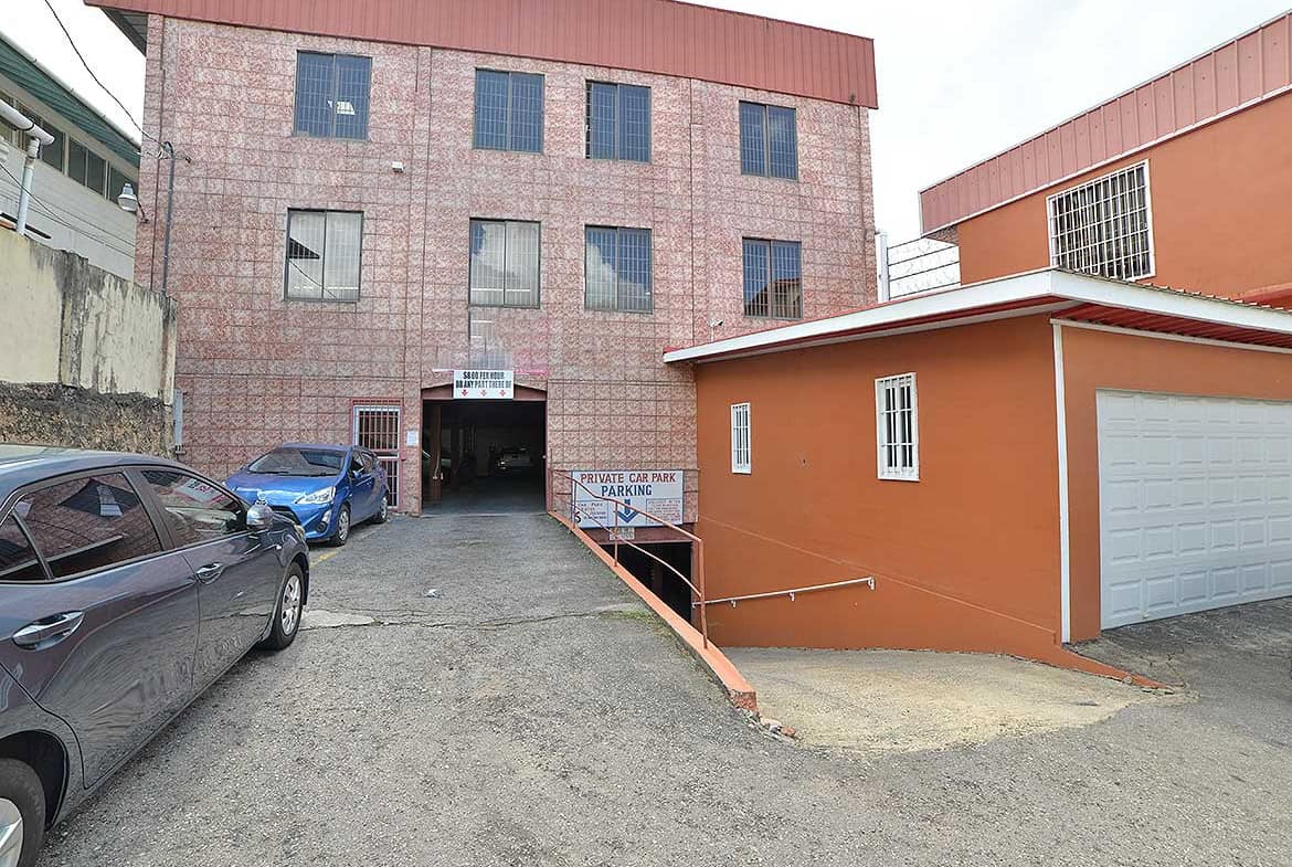 Cornerstone- Multi-story commercial building with parking area on St James Street.