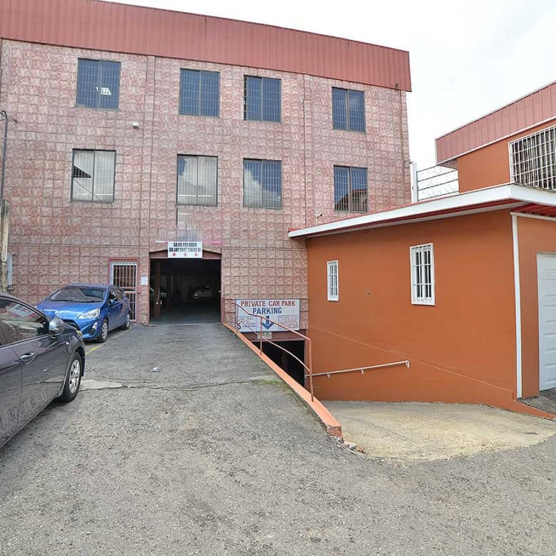 Cornerstone- Multi-story commercial building with parking area on St James Street.