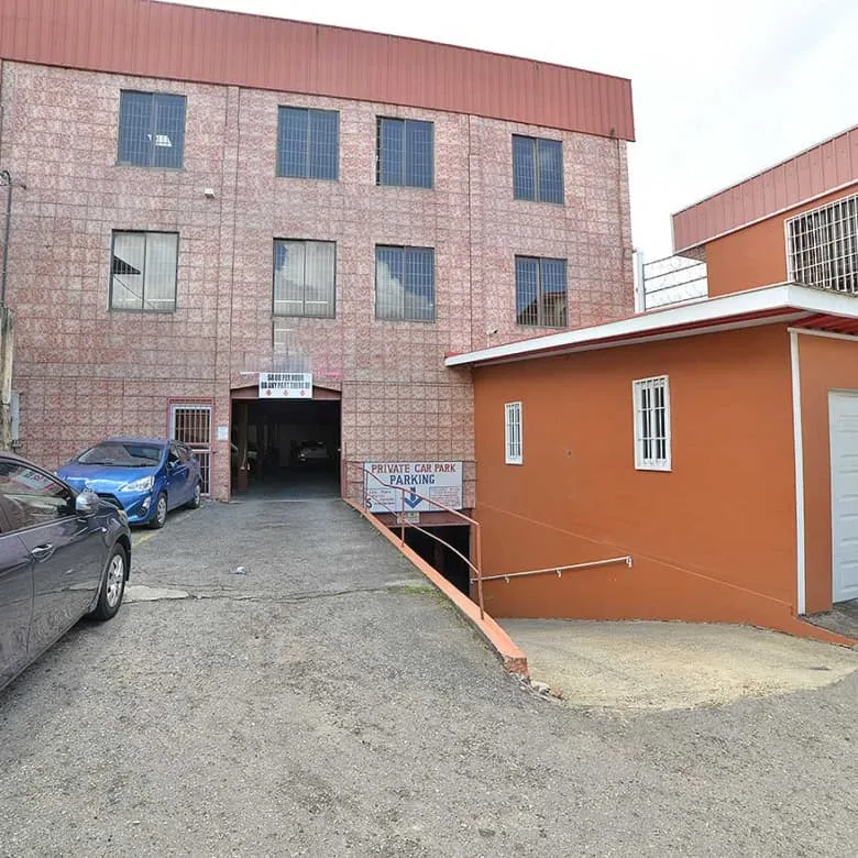 Cornerstone- Multi-story commercial building with parking area on St James Street.