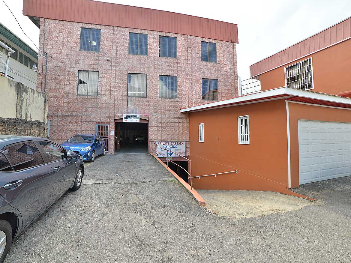 Cornerstone- Multi-story commercial building with parking area on St James Street.