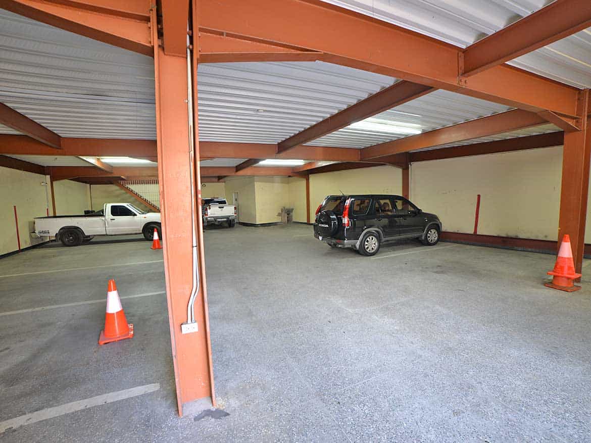 Underground Parking Lot at Cornerstone Cornerstone- Underground parking garage with cars and orange safety cones.