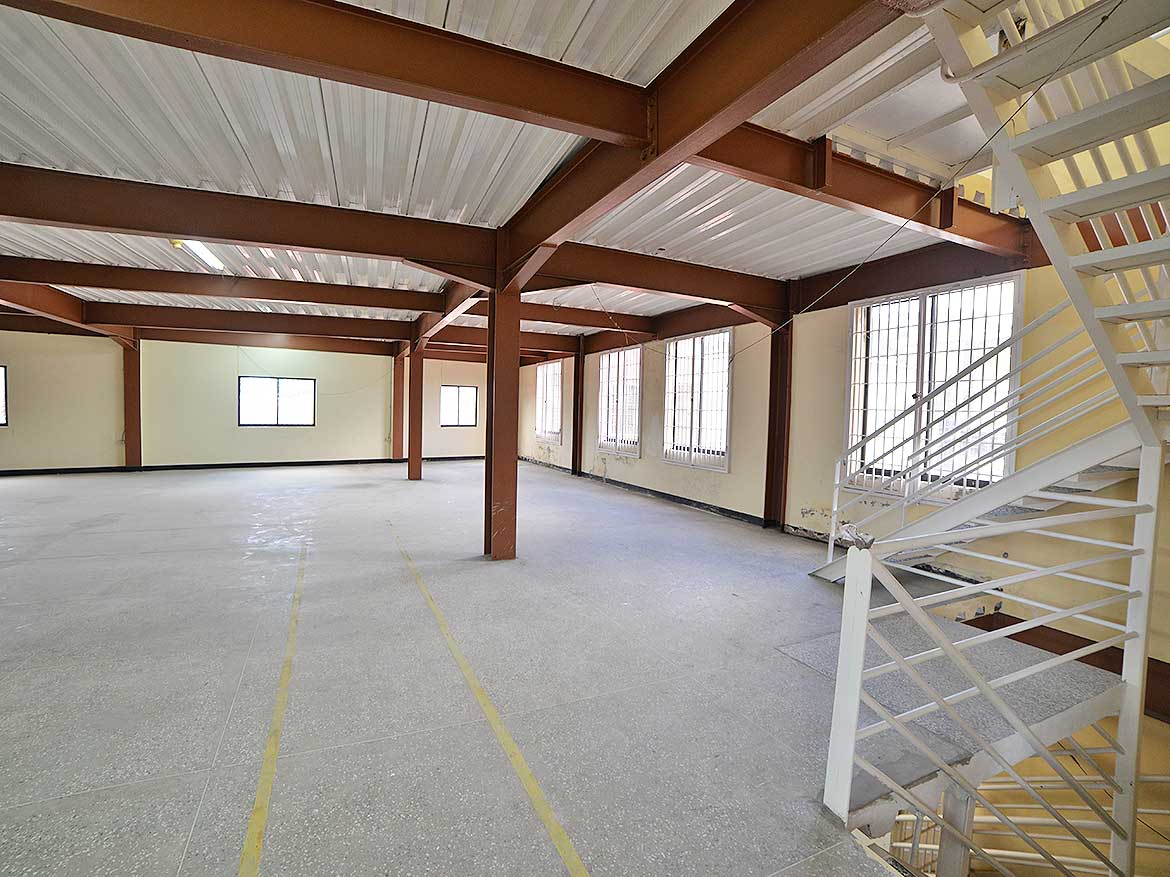 Spacious Commercial Interior at Cornerstone Cornerstone- Open industrial space with large windows and metal staircase at Cornerstone.