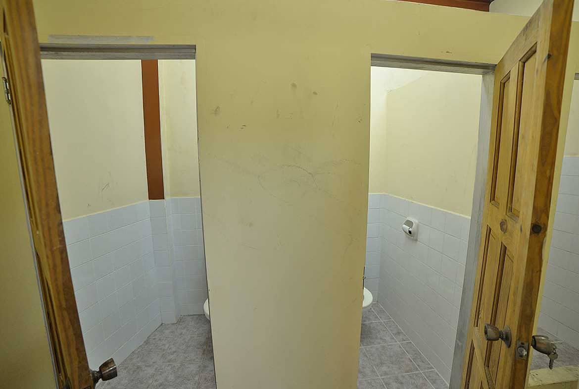 Cornerstone- Public restroom with two stalls and wooden doors on St James Street.