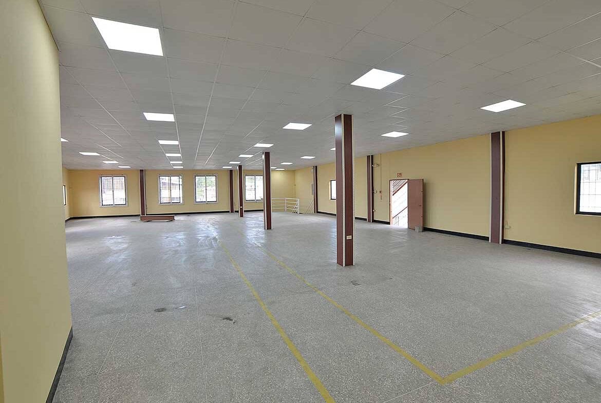Cornerstone- Open-plan office space with yellow walls and large windows in St James.