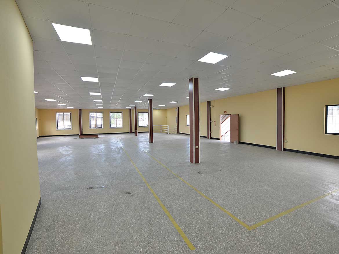 Spacious Commercial Office Space in St James Cornerstone- Open-plan office space with yellow walls and large windows in St James.