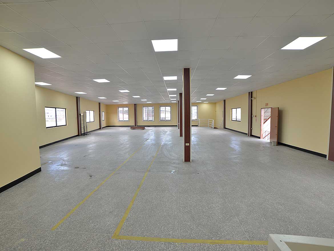 Spacious Commercial Interior for Lease Cornerstone- Large empty commercial space with high ceilings and multiple windows.