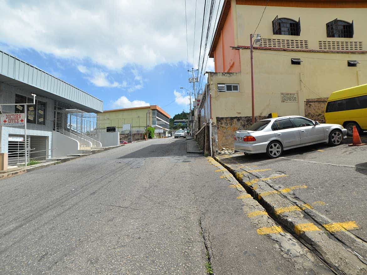 St James Street in Port of Spain Cornerstone- View of St James Street with parked cars and buildings in Port of Spain.