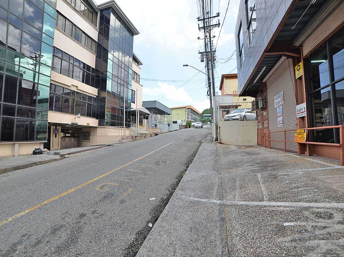 St James Street Commercial Area Cornerstone- Empty street in St James with modern buildings and utility poles.