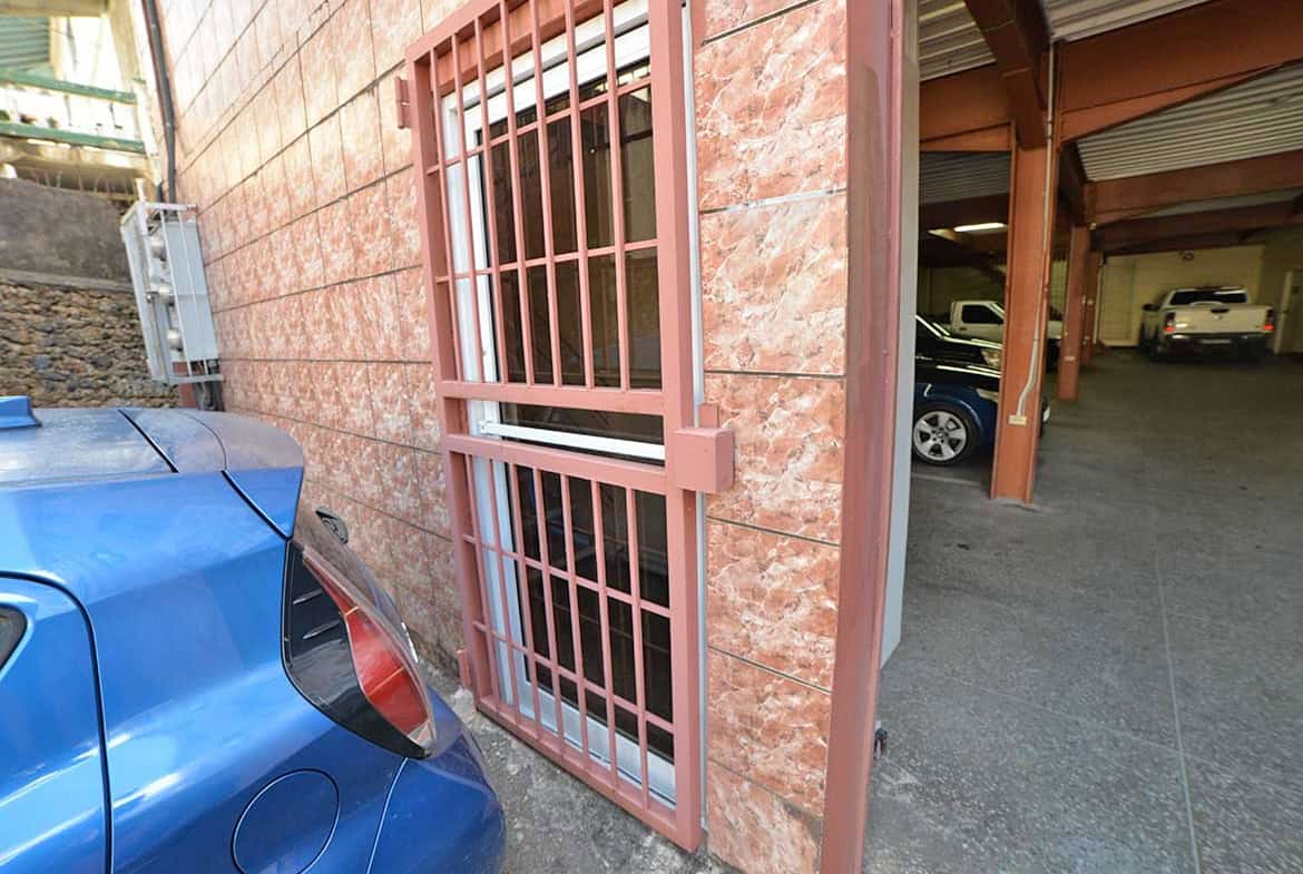 Cornerstone- Parking area and building with pink security bars at Cornerstone™.