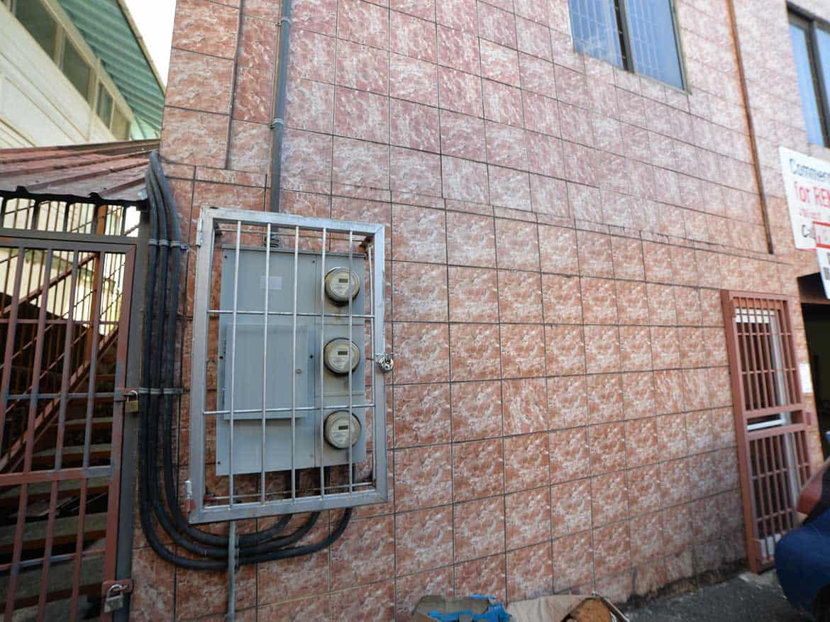Cornerstone™ Building Exterior Wall Cornerstone- Close-up of building exterior wall with electrical meter box and wiring.