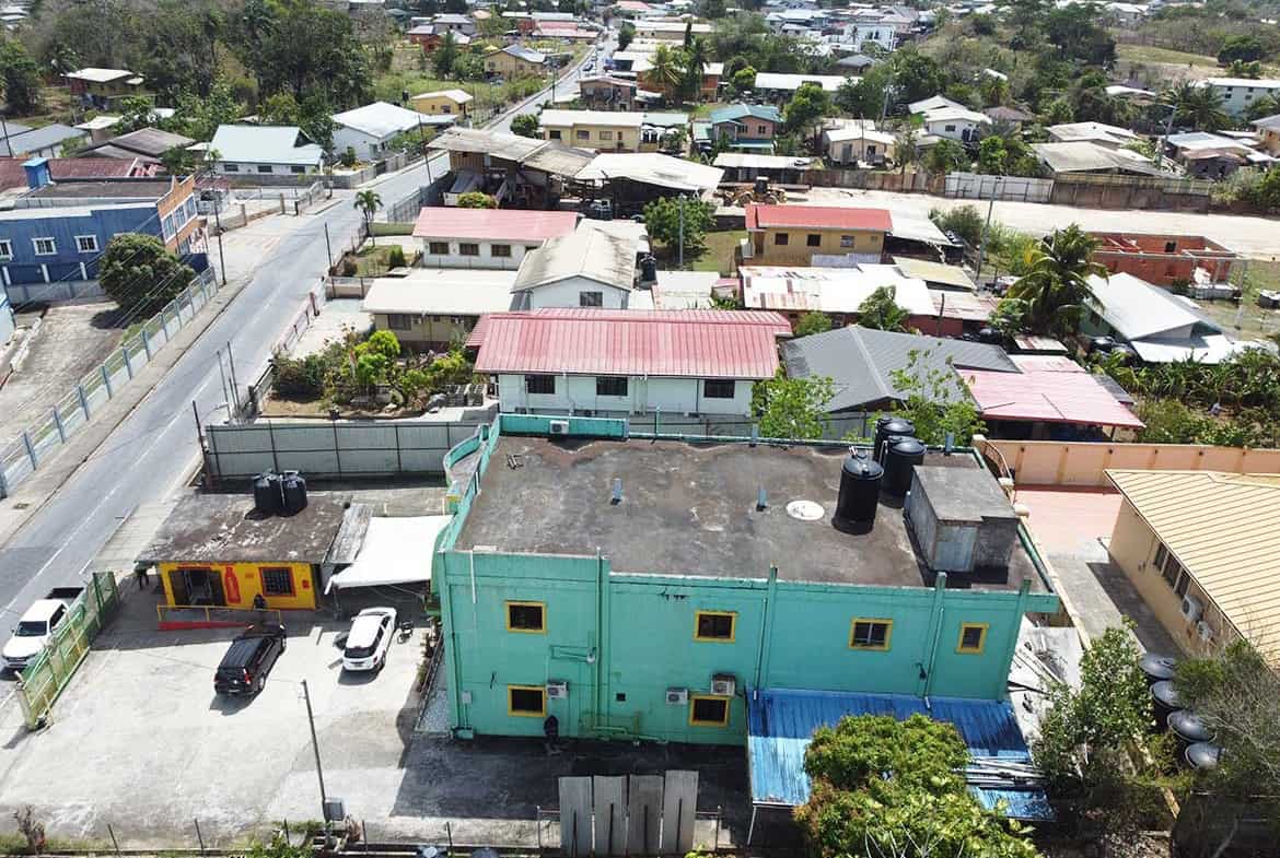Cornerstone- Aerial view of a colorful residential neighborhood in Bonne Aventure, Trinidad.