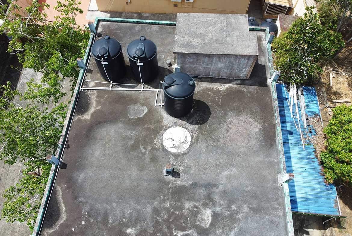 Cornerstone- Aerial view of rooftop water tanks and equipment on a building.