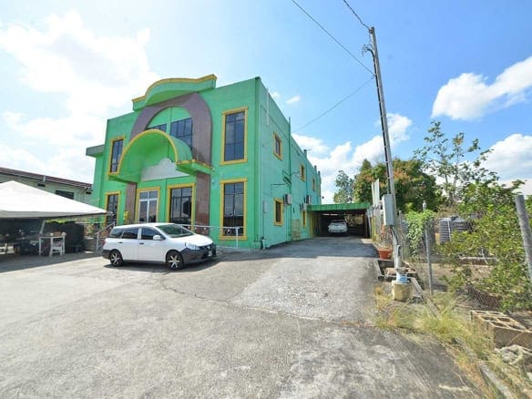 Cornerstone- Colorful Cornerstone™ building on Bonne Aventure Road with parking lot.