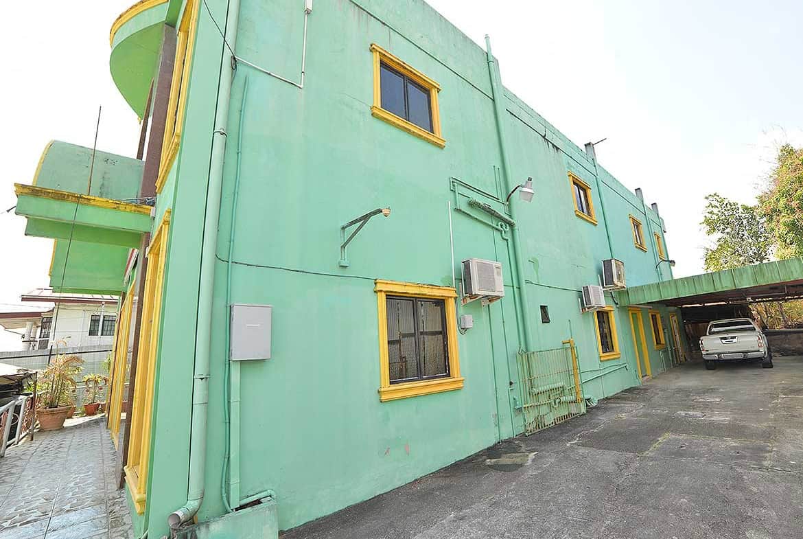 Cornerstone- Colorful green building with yellow window frames on Bonne Aventure Road.