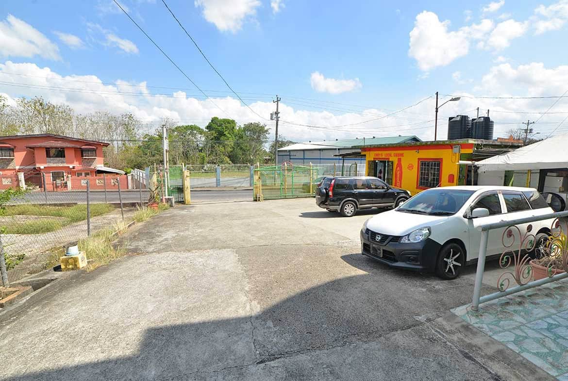 Cornerstone- Parking lot with cars and buildings on Bonne Aventure Road.