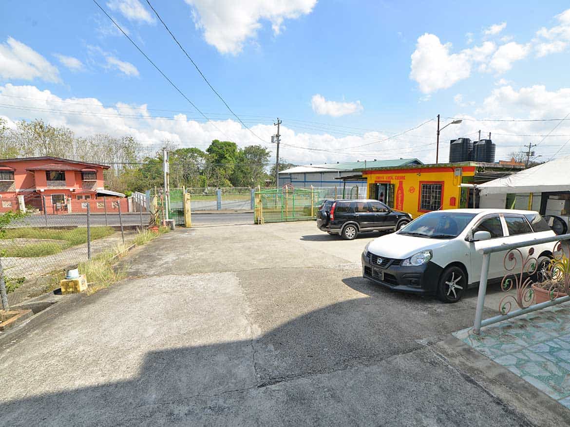 Cornerstone™ Parking Area in Bonne Aventure Road Cornerstone- Parking lot with cars and buildings on Bonne Aventure Road.