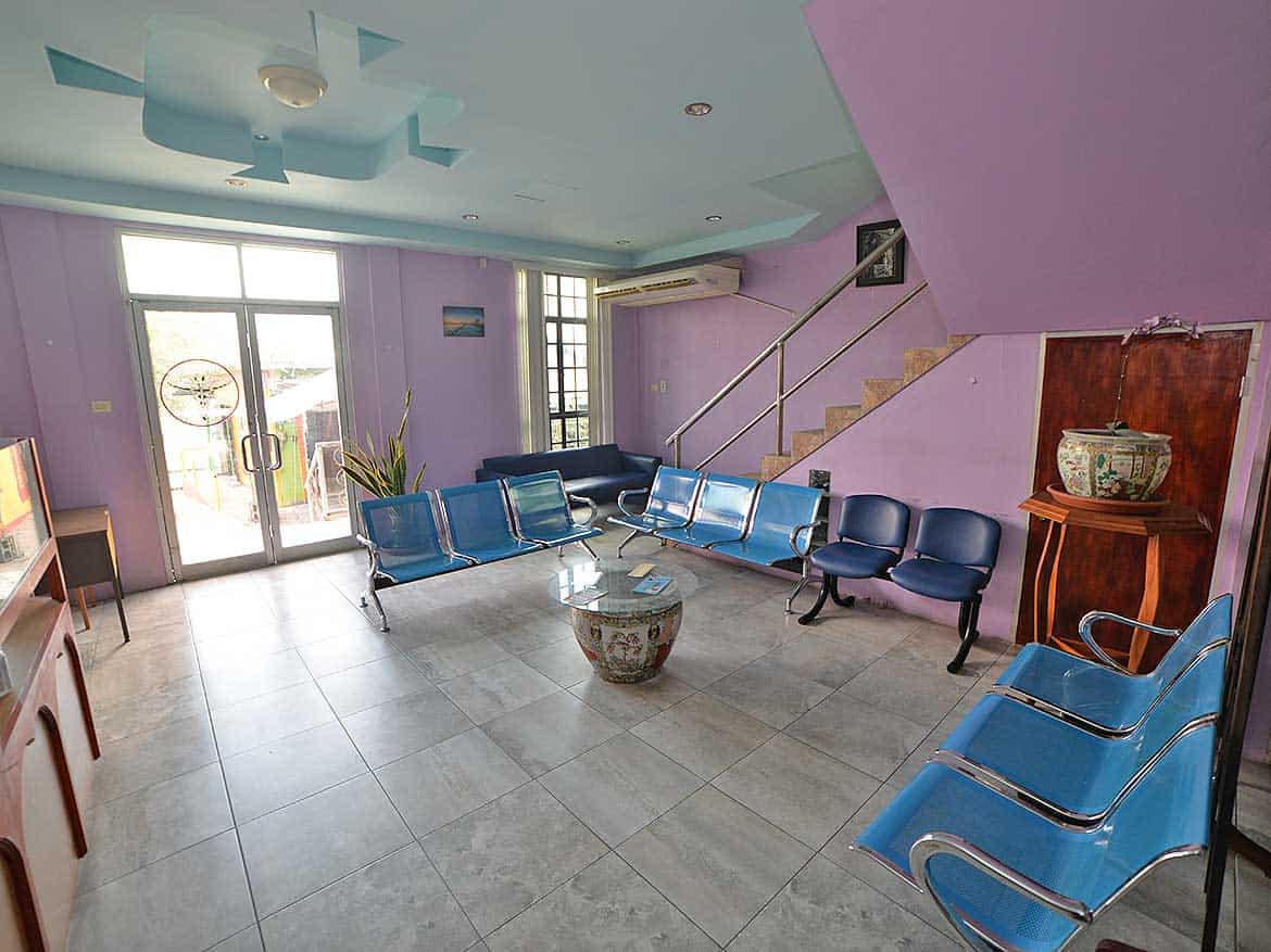 Cornerstone™ Office Lounge Area Cornerstone- Modern office lounge with purple walls and blue chairs for visitors.
