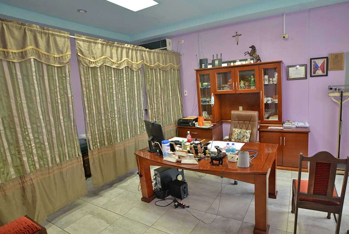 Cornerstone- Office space with desk, chairs, and purple walls at Cornerstone™.