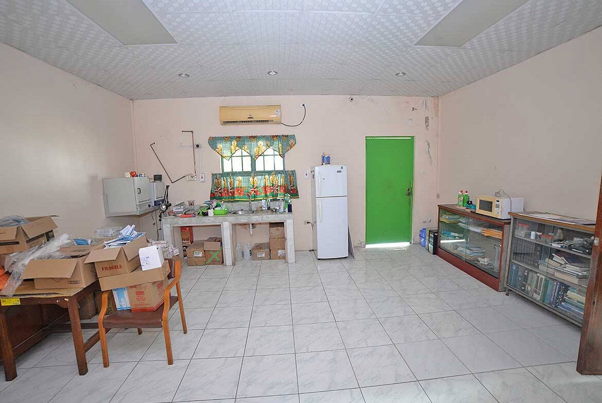 Cornerstone- Simple kitchen and dining space with basic appliances and furniture.