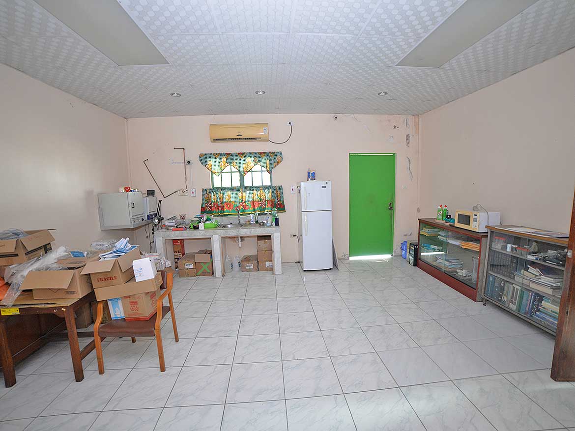 Interior of a modest kitchen and dining area Cornerstone- Simple kitchen and dining space with basic appliances and furniture.