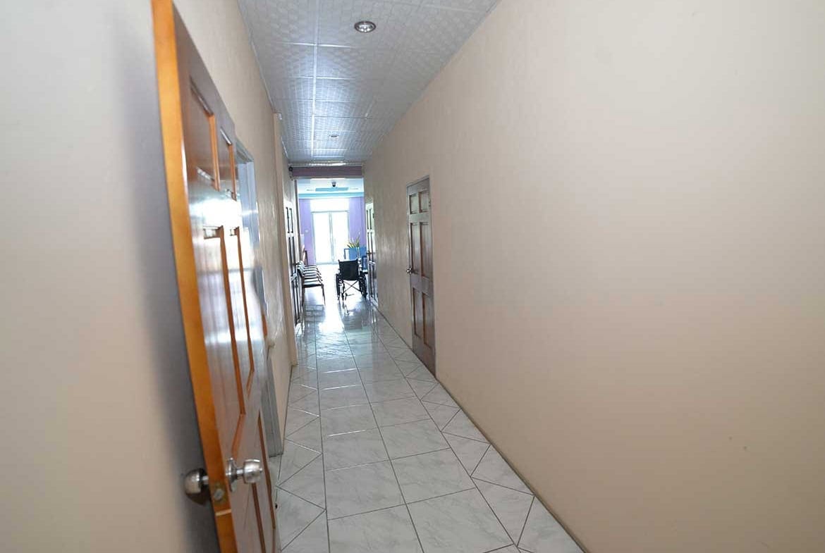 Cornerstone- Long corridor inside Cornerstone office building with doors and windows.
