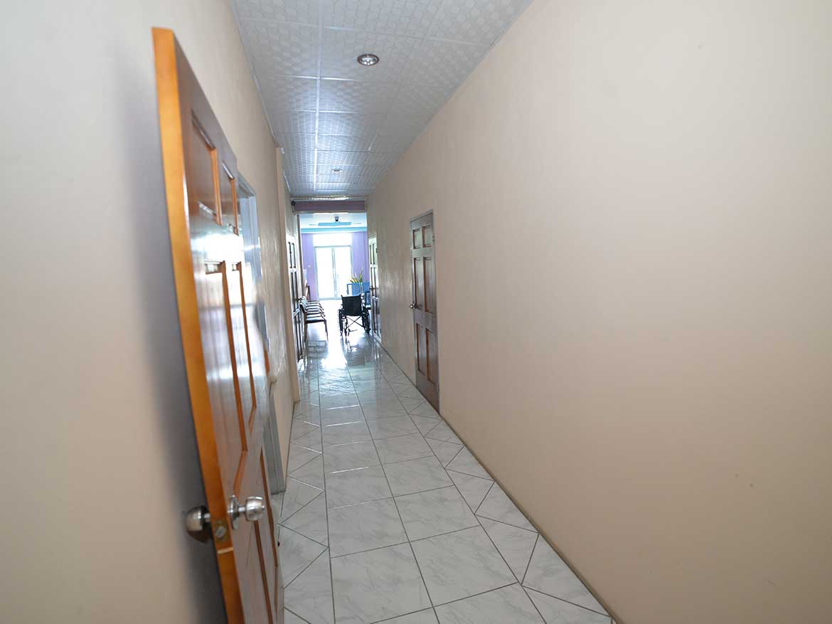 Interior hallway at Cornerstone Cornerstone- Long corridor inside Cornerstone office building with doors and windows.