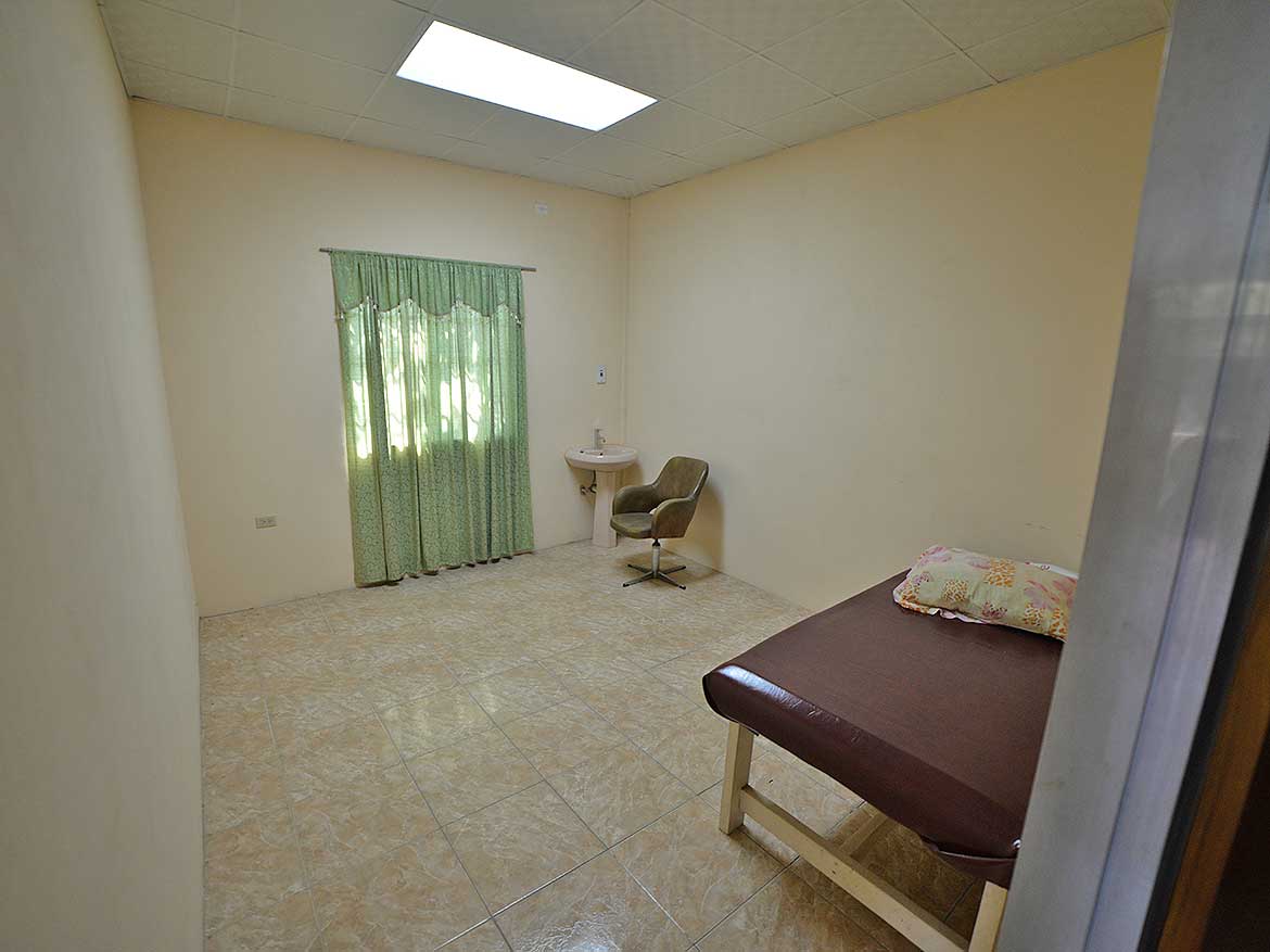 Simple Room with Bed and Window Cornerstone- Basic room with bed, window, and small desk in a healthcare facility.