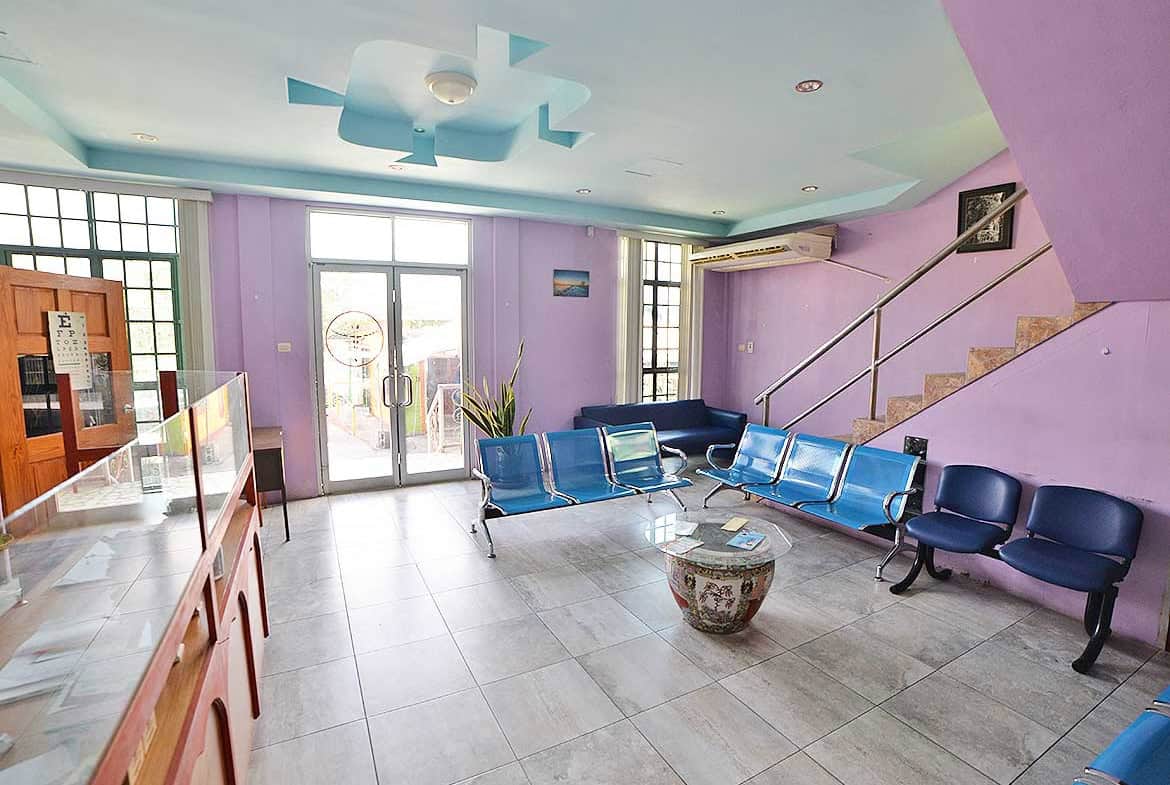 Cornerstone- Modern office lobby with blue seating and purple walls at Cornerstone™.