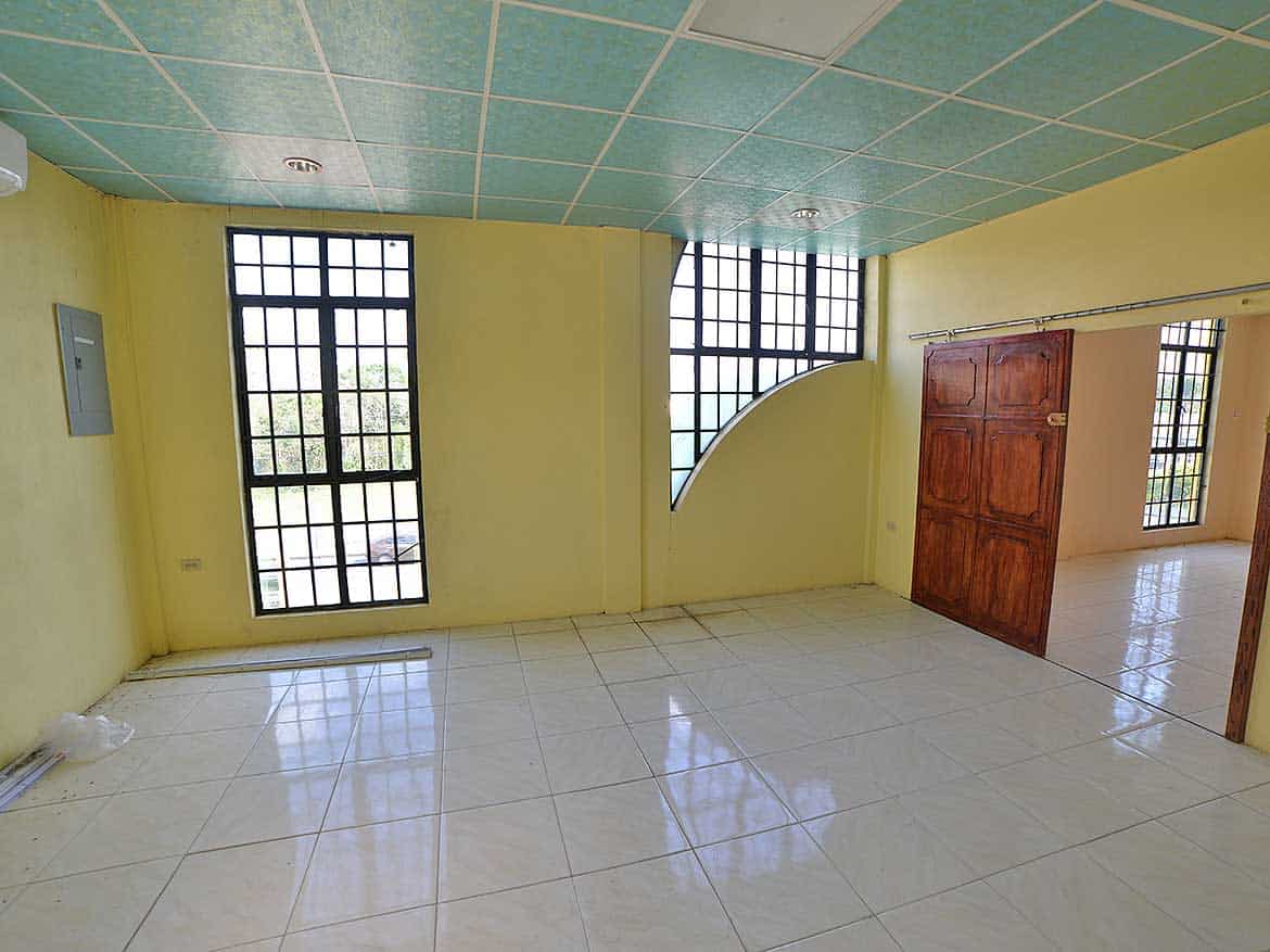 Spacious Room with Large Windows Cornerstone- Bright empty room with large windows and tiled floor in Bonne Aventure Road.