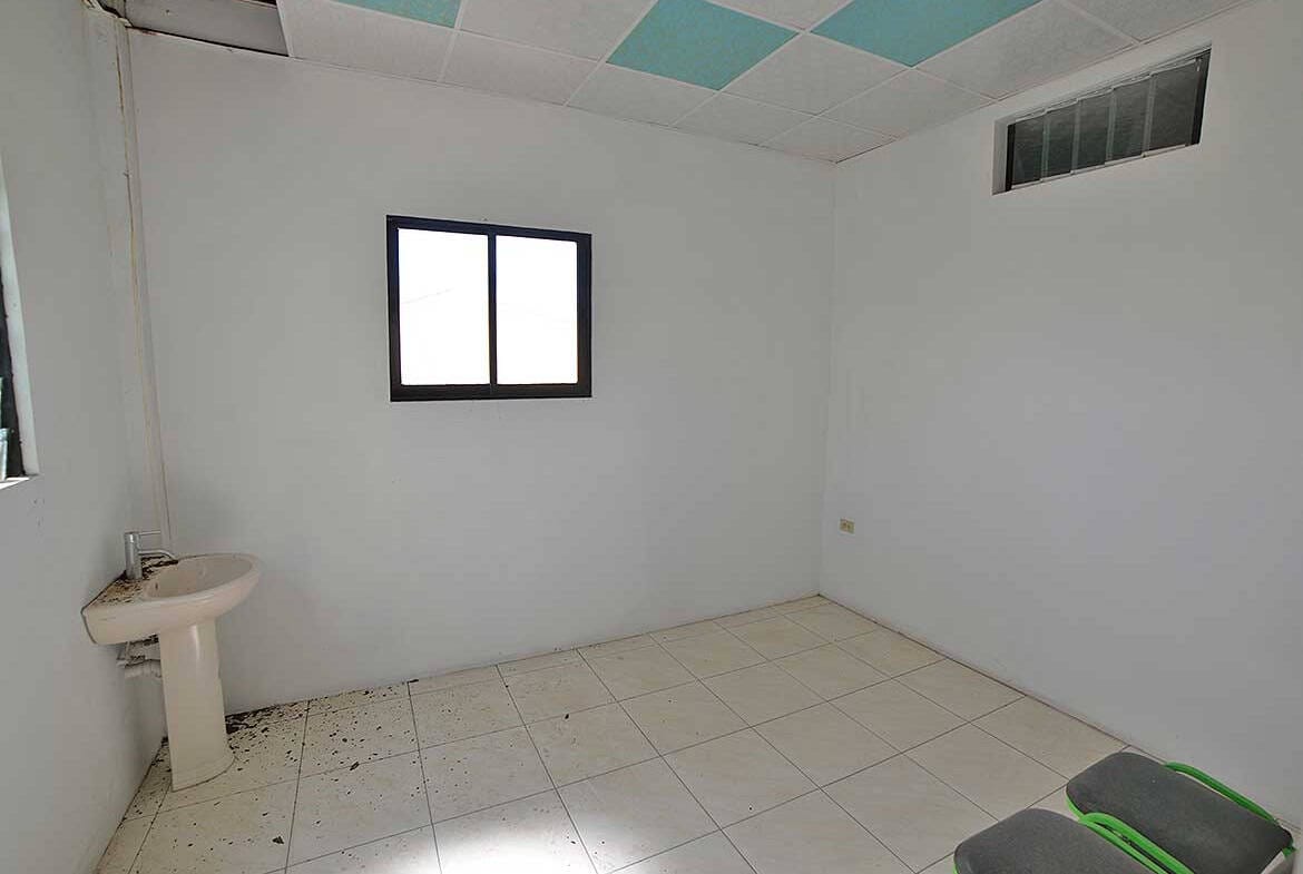 Cornerstone- Empty room with white walls, tiled floor, and a window.