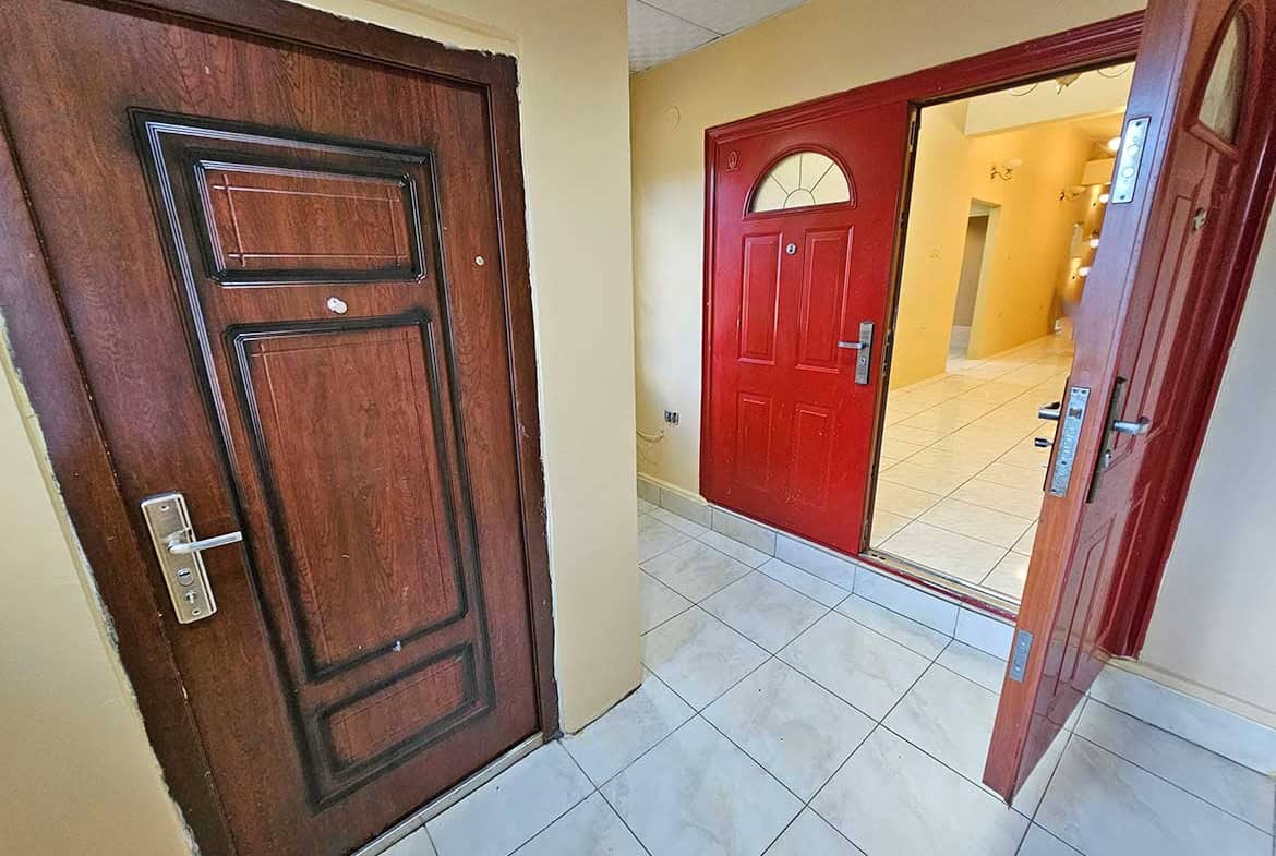 Cornerstone- Residential entrance with wooden and red doors at Cornerstone™.