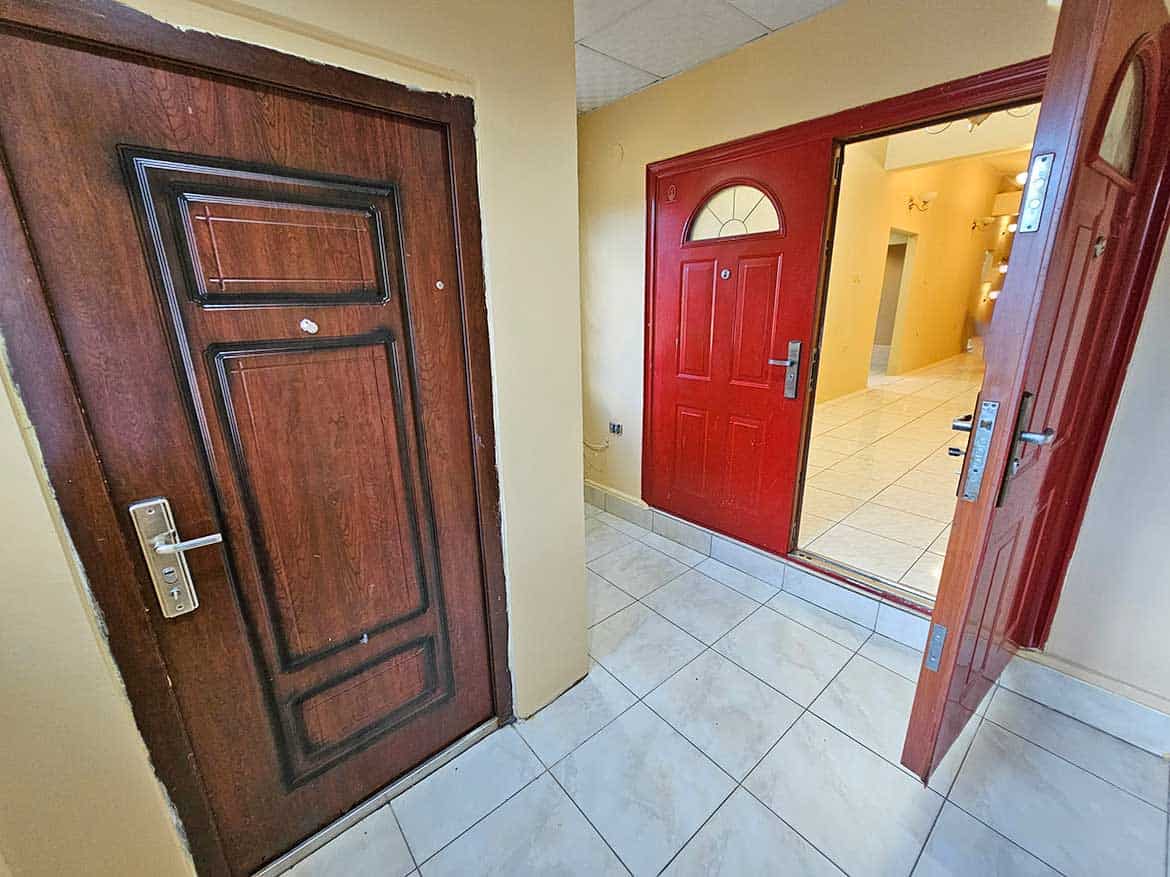 Cornerstone™ Residential Entrance Cornerstone- Residential entrance with wooden and red doors at Cornerstone™.